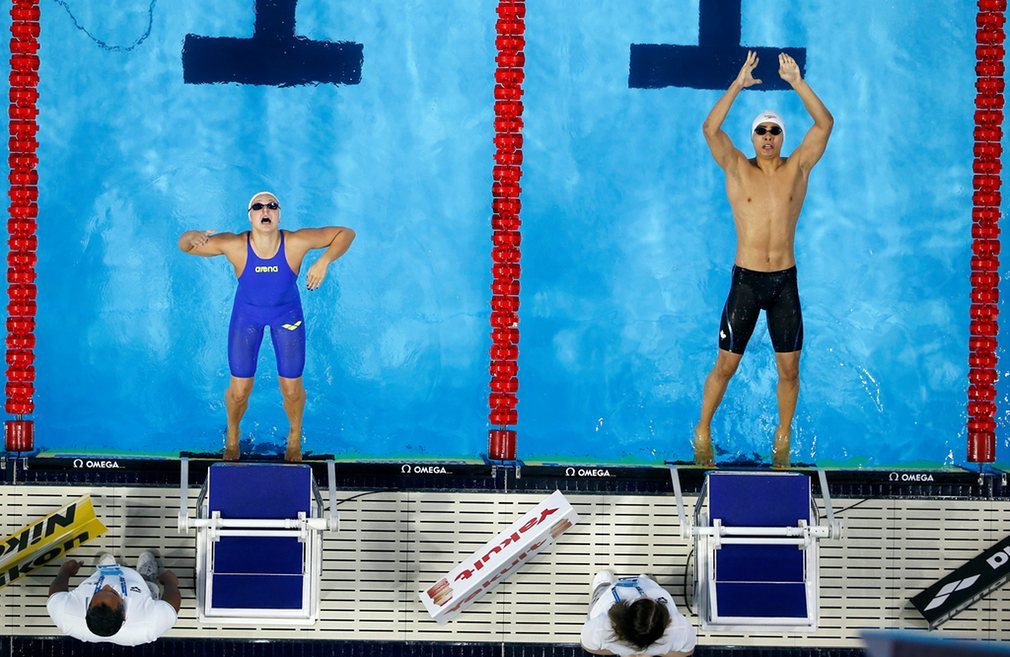 fanny-teijonsalo-of-finland-left-and-javier-acevedo-of-canada-compete-in-the-mixed-4x50m-medley-relay-heats