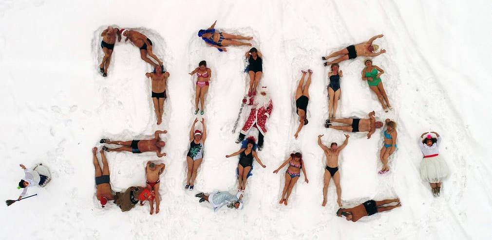 Cryophile winter swimming club of Siberia form their bodies into a 2018 sign