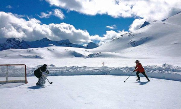 Mountie Shaun Begg playing a game of shinny on a rink built on a glacier near Invermere